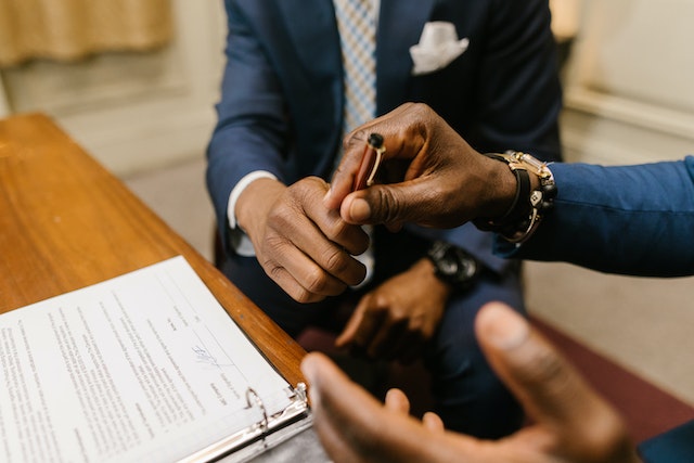 people signing documents